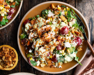 a plate of Grilled Chicken & Corn Salad with creamy dill dressing and breadcrumbs over top